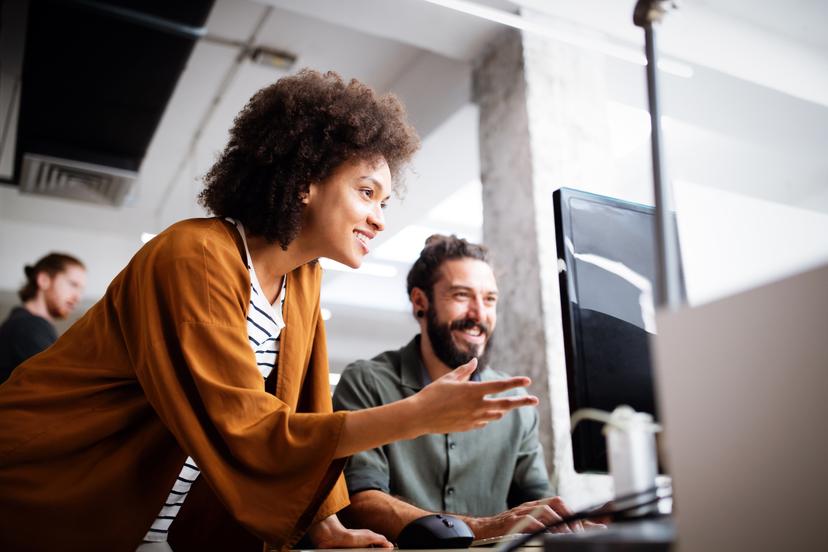 Two peope around computer